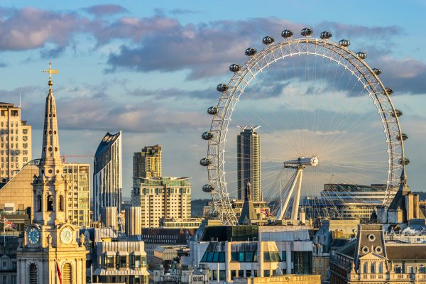 London eye against a London skyline with blue sky and purple clouds