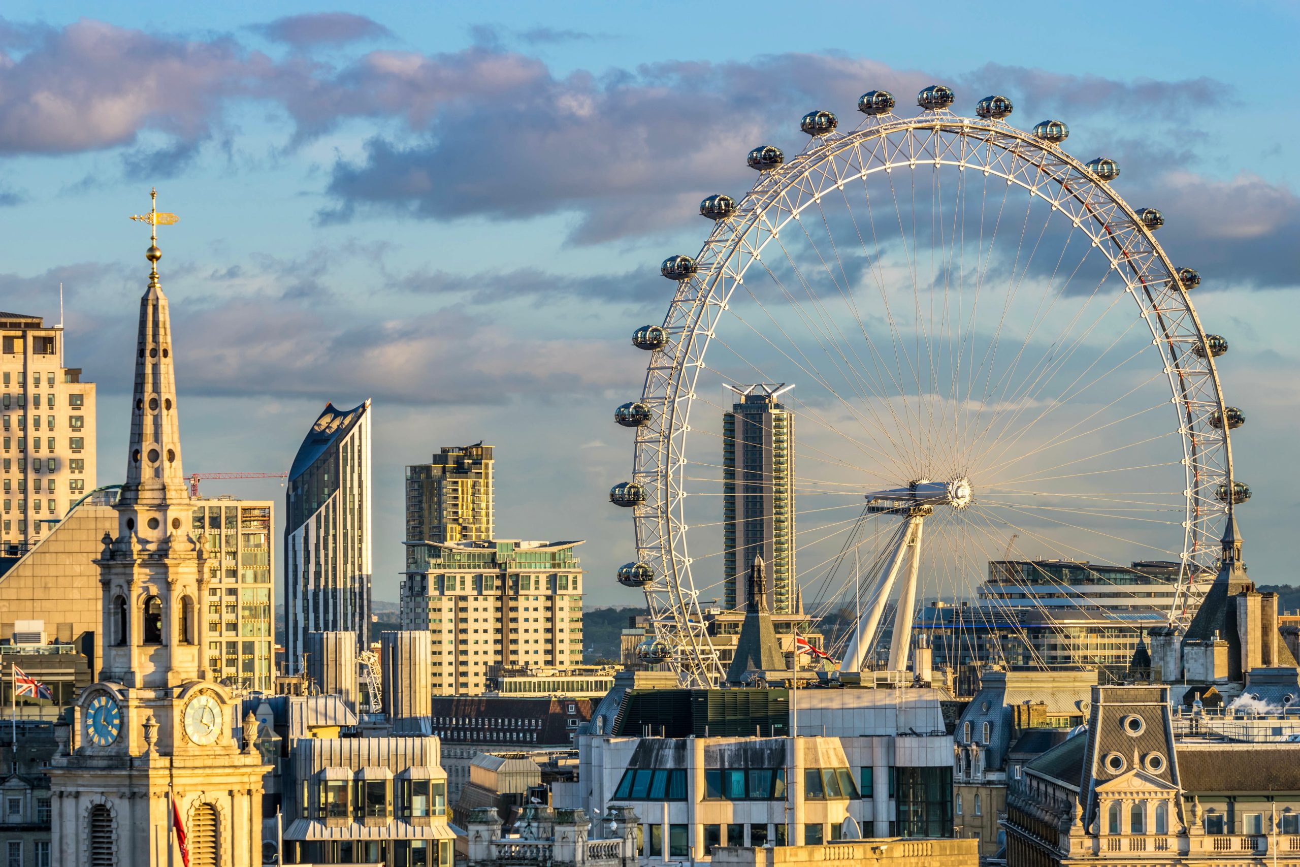 London eye against a London skyline with blue sky and purple clouds